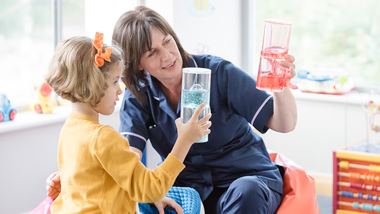 Nurse playing a game with a child patient